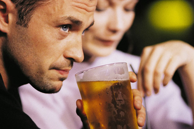Image of person about to drink a glass of beer.