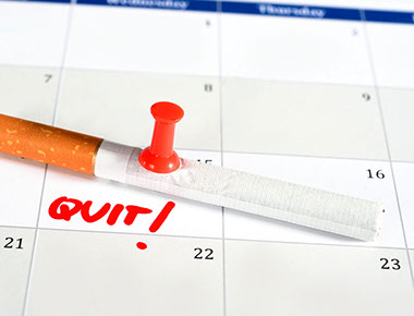 Image of a cigarette on a calendar with the word "Quit!" next to it.