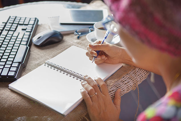 Person writing in notebook.