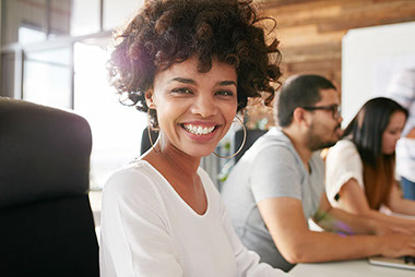 Image of smiling women at desk.