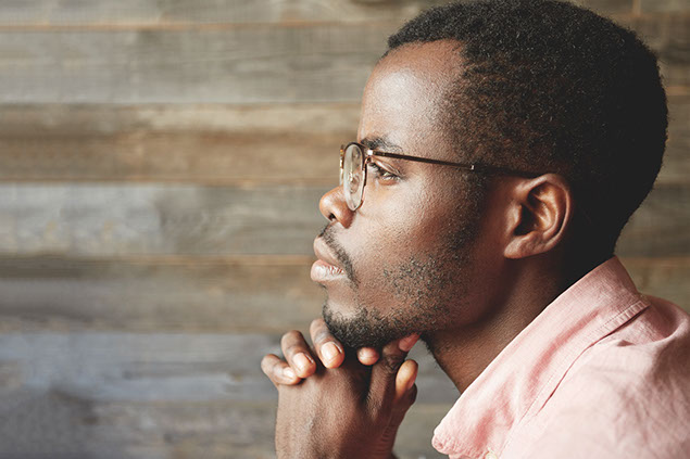 Profile image of man, sitting thinking.