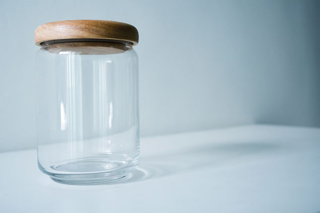 An empty clear glass jar.