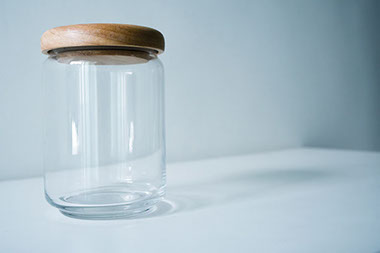 An empty clear glass jar.