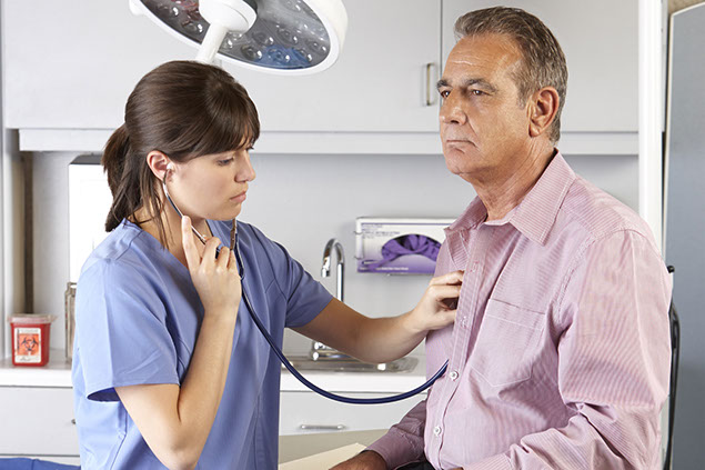 Image of doctor listening to patient's heart.